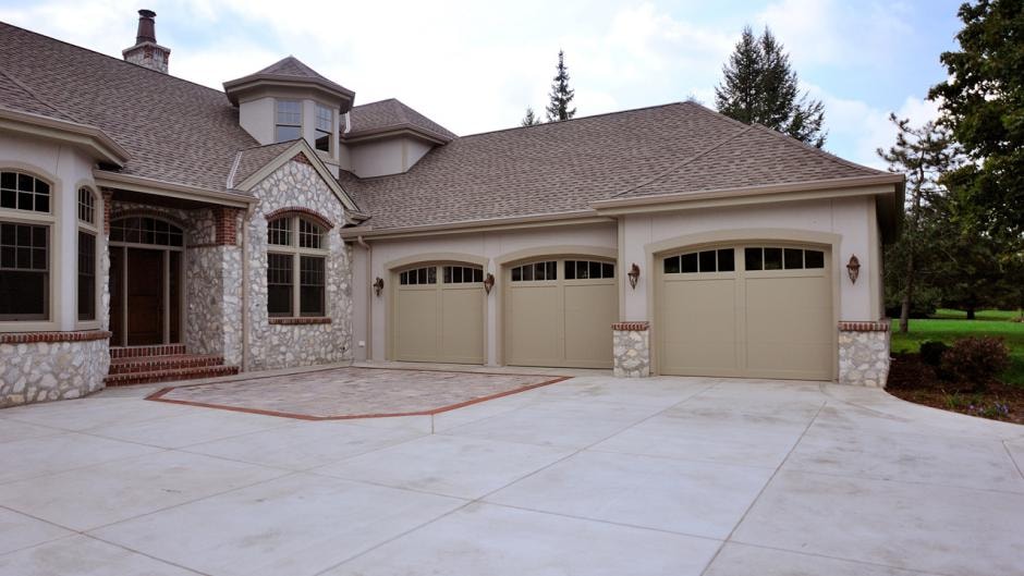 Carriage house style garage doors with stone accents