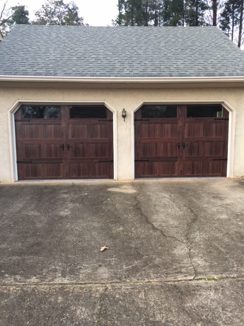 Steel garage door with wood stain finish