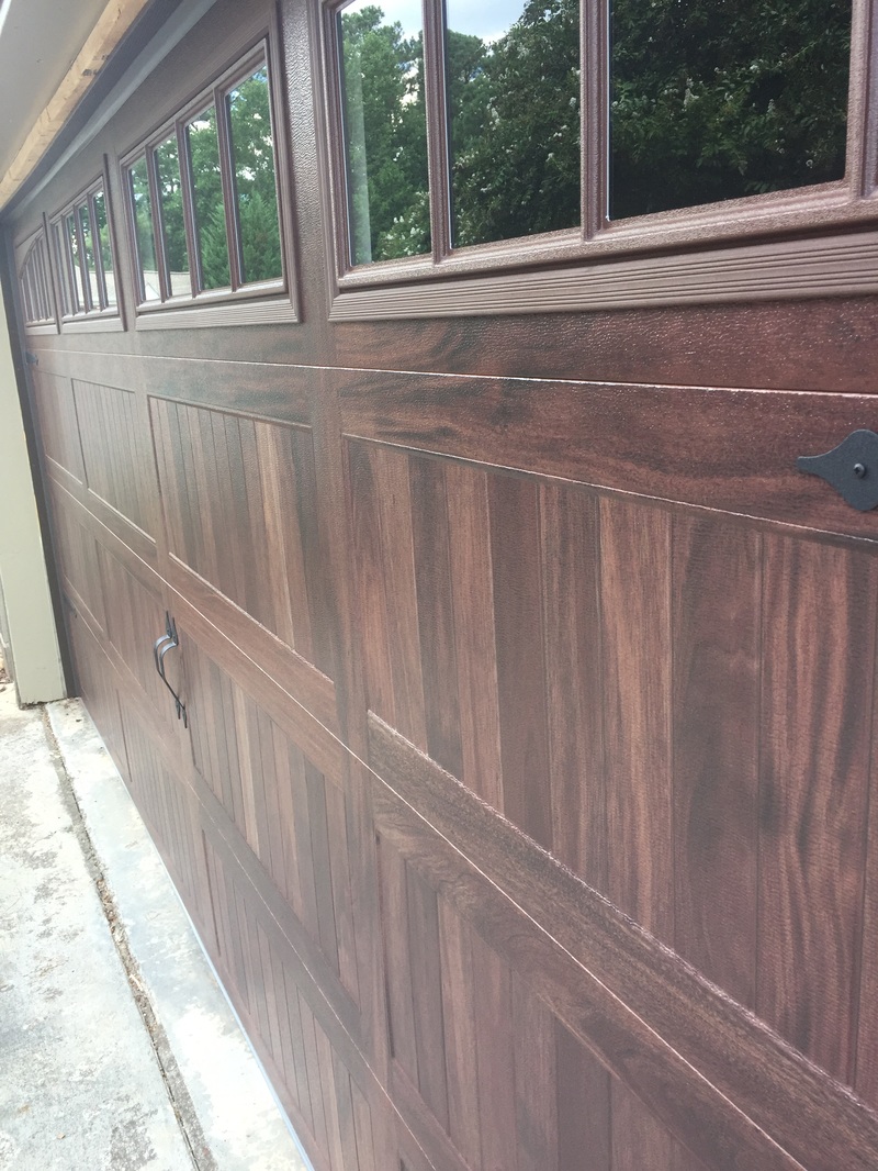 Steel garage door with wood stain finish
