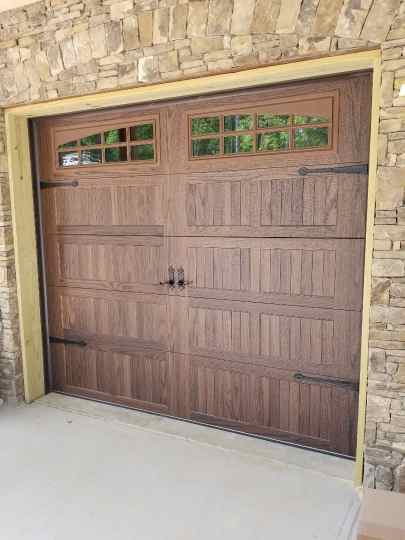 Steel garage door with wood stain finish