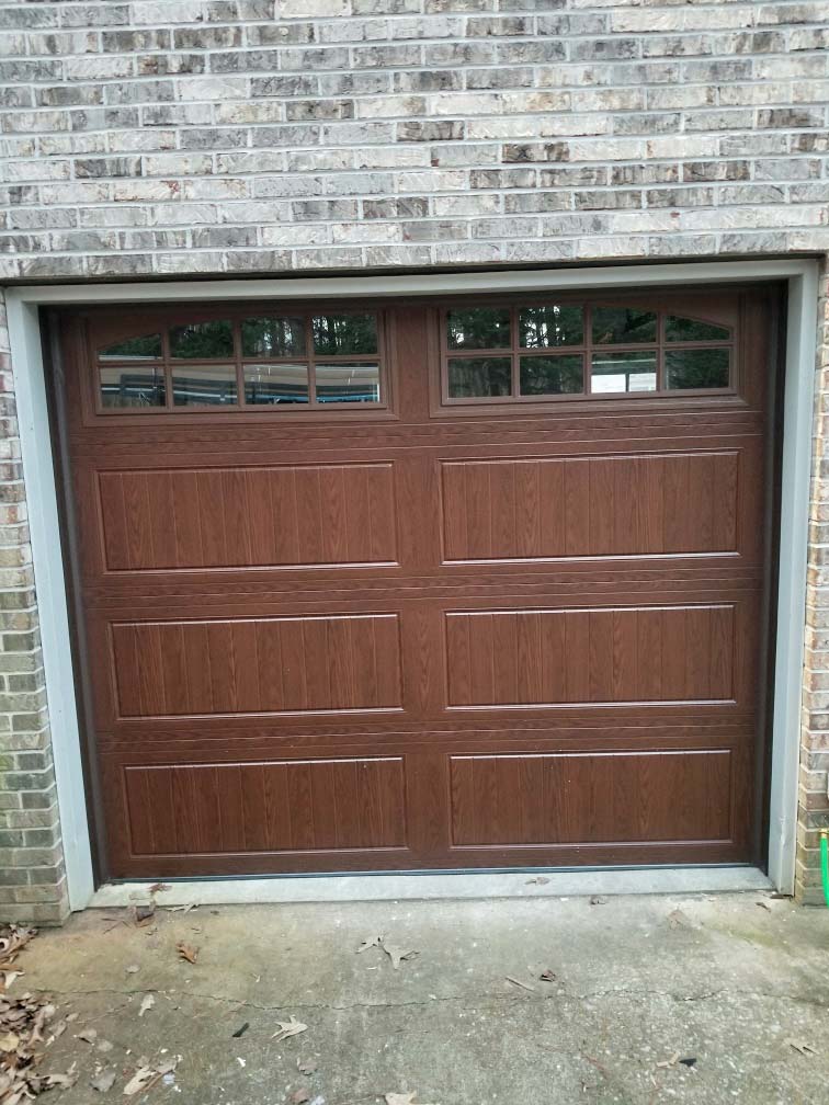 Steel garage door with wood stain look